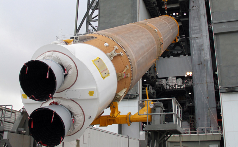 The first stage of the Atlas V rocket for NASA's Mars Science Laboratory (MSL) mission is lifted into an upright position for placement inside the Vertical Integration Facility at Space Launch Complex 41 on Cape Canaveral Air Force Station.