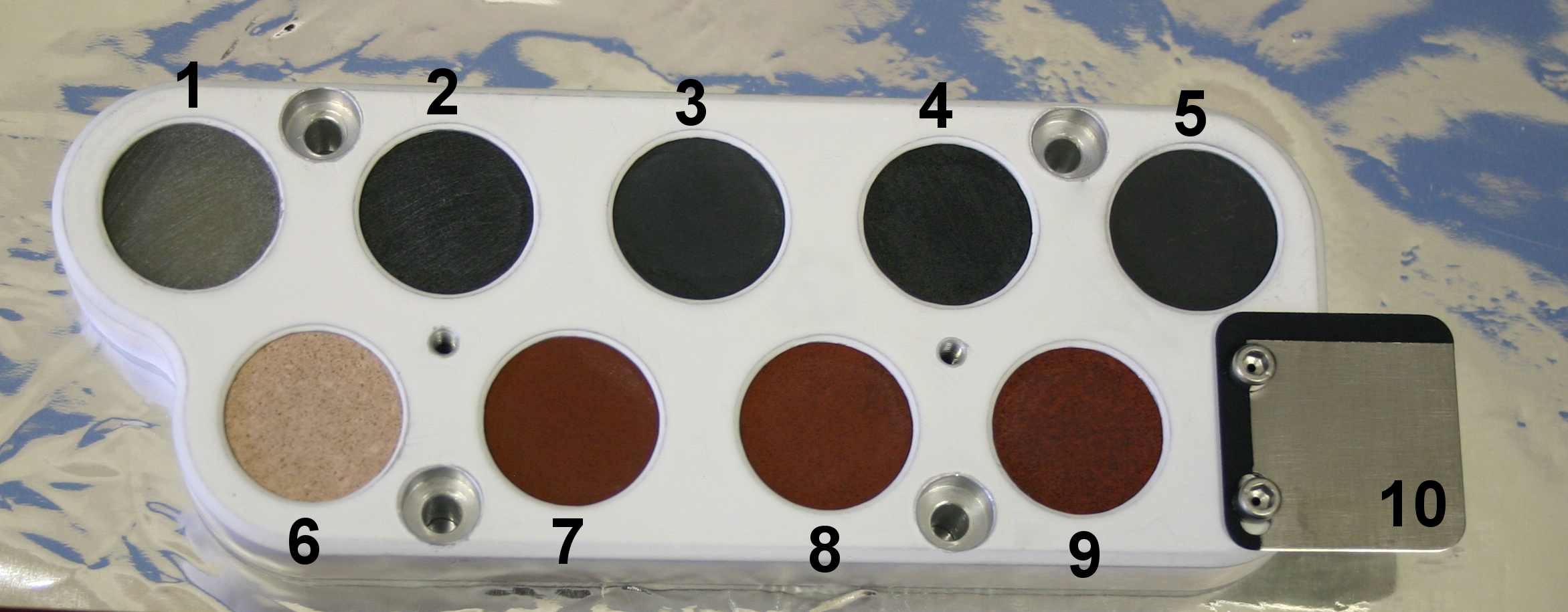 This image shows the calibration target for the Chemistry and Camera instrument on NASA's Curiosity rover before it was installed on the rover and readied for launch.